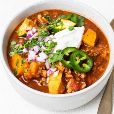 A bowl of paleo turkey chili shown garnished with jalapeno and cilantro.