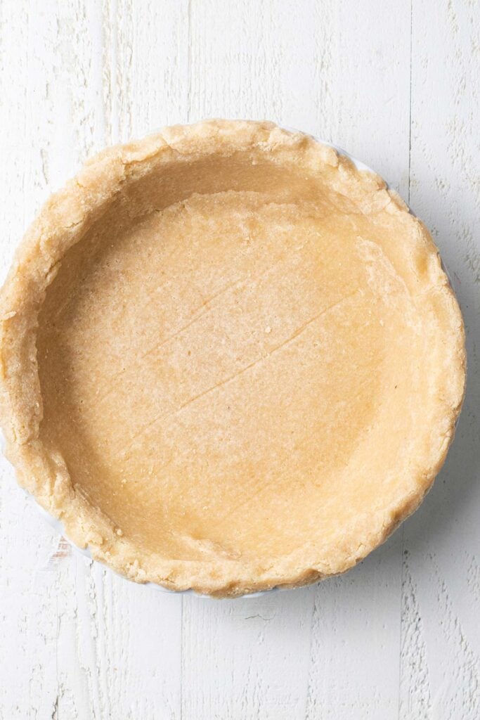 A prebaked almond flour pie crust ready for a filling.