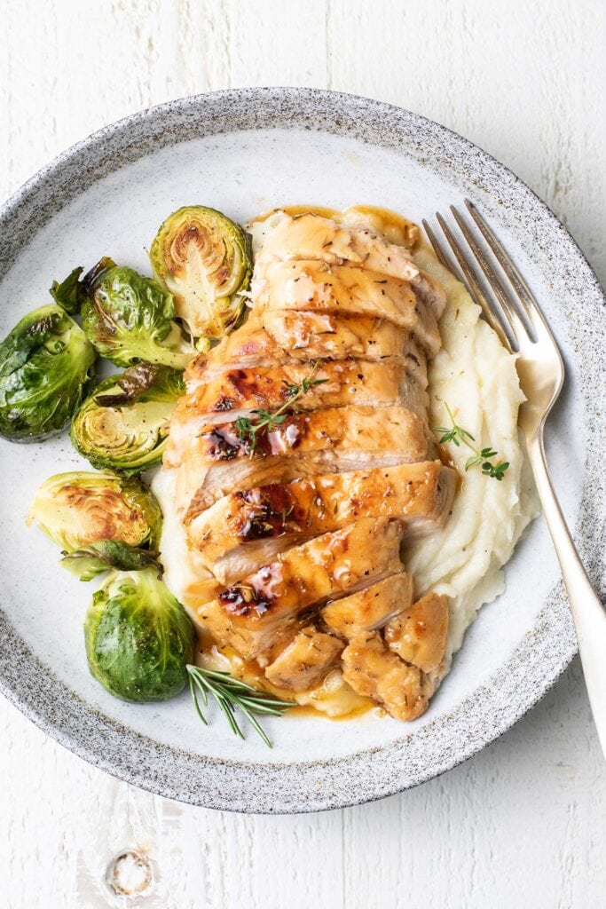 Honey chicken served with cauliflower mash and roasted brussels sprouts.