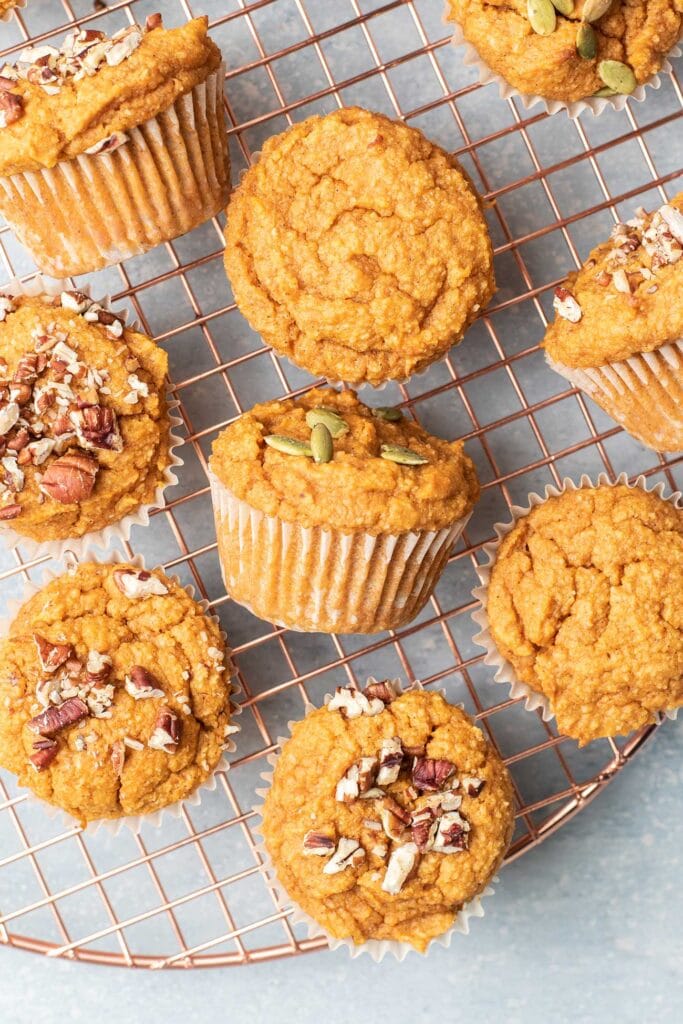 Sweet potato muffins shown with different toppings on a cooling rack.