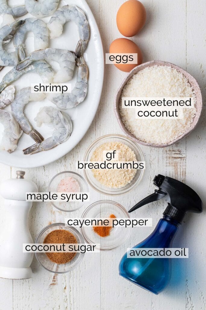 The ingredients needed to make coconut shrimp in an oven.