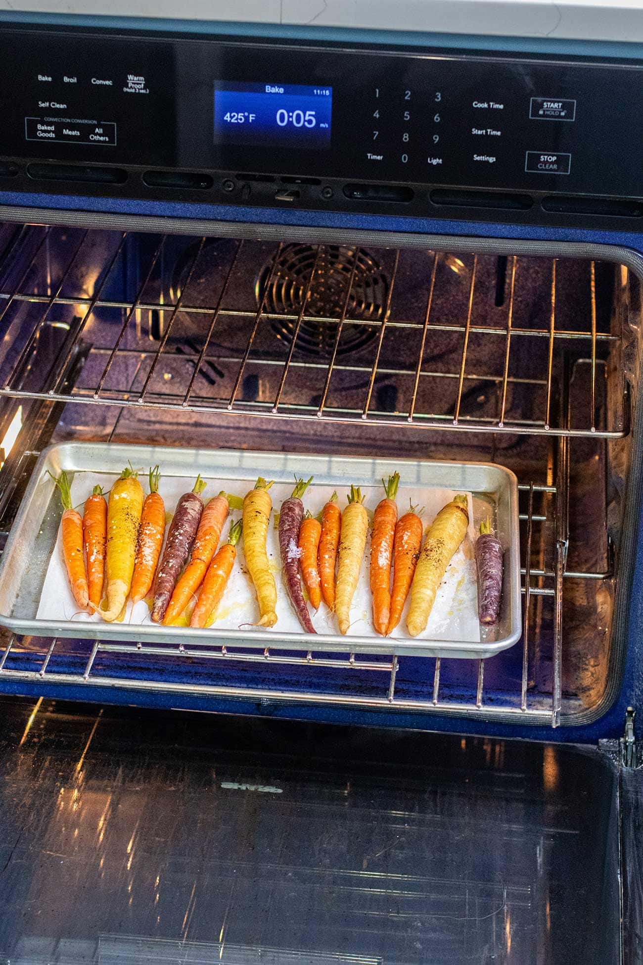Rainbow carrots in an oven.