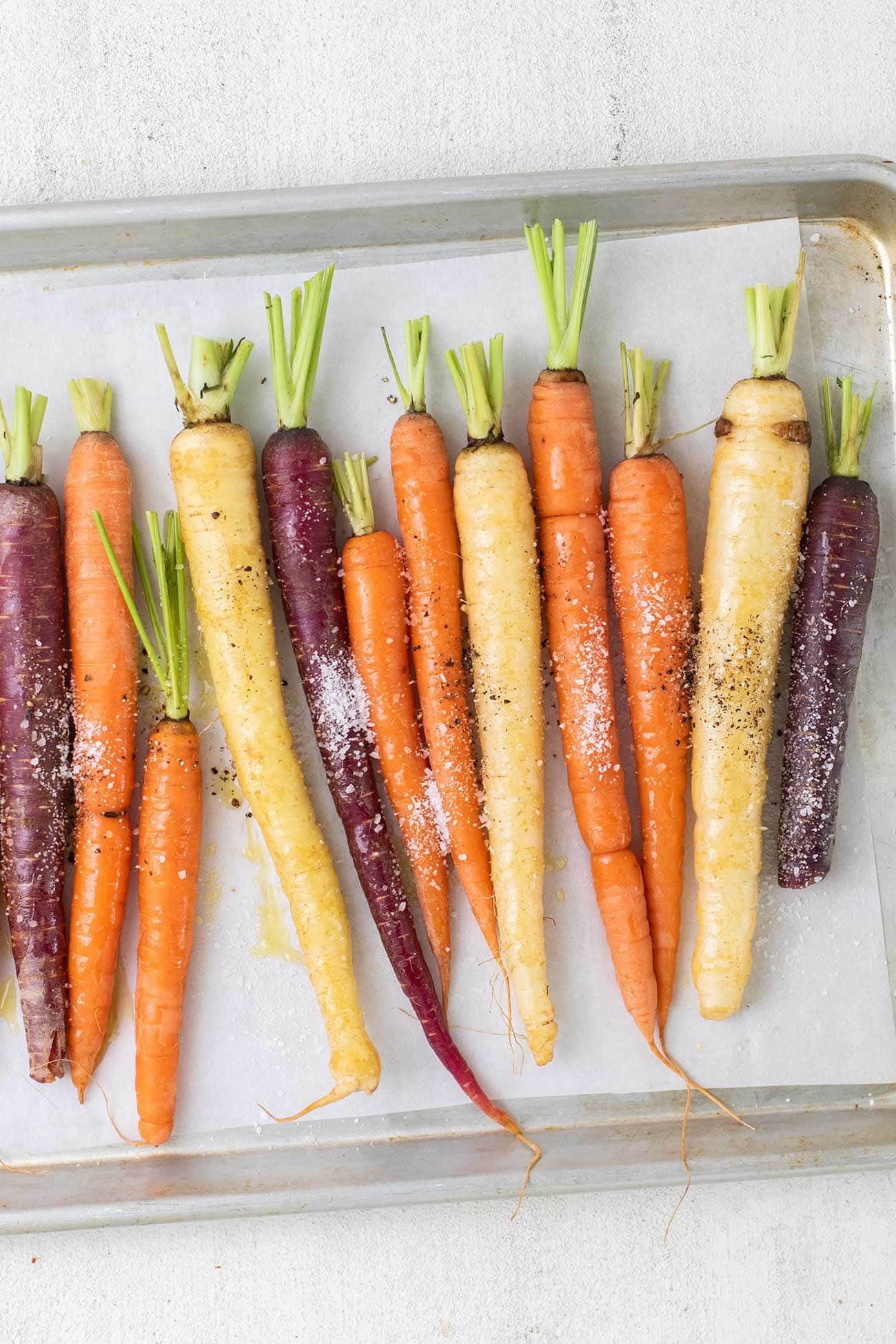 Rainbow carrots sprinkled with kosher salt and black pepper.
