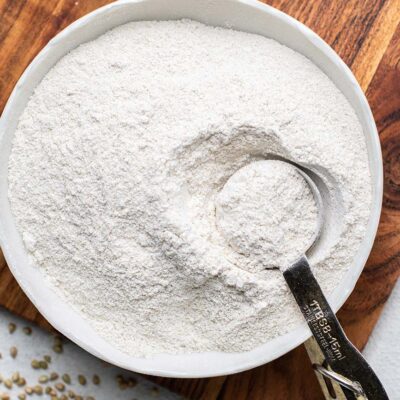 Buckwheat flour in a bowl with a measuring spoon.