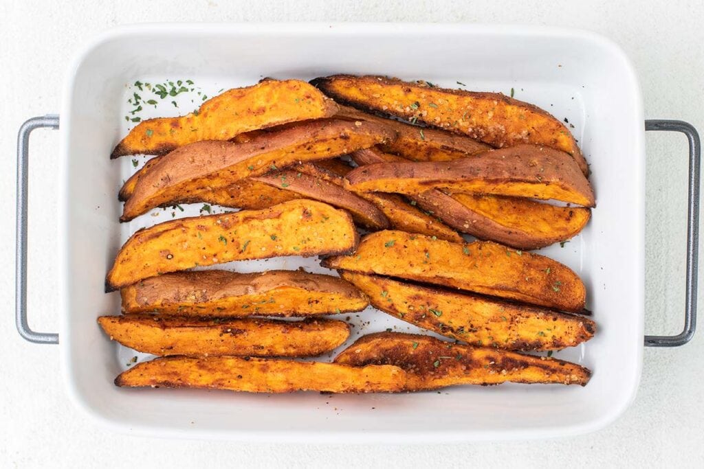 Sweet potato wedges shown baked with crisp brown edges.