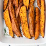 Roasted sweet potato wedges shown baked until browned.