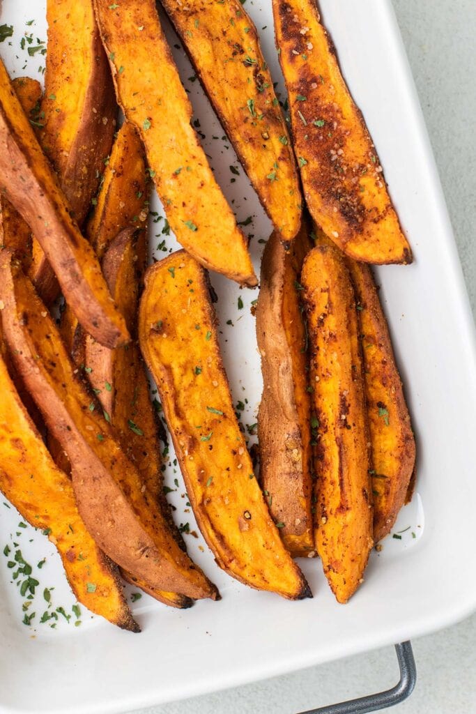 A serving dish shown with oven roasted sweet potatoes.