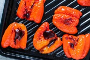 Add peppers to a baking tray, skin side up