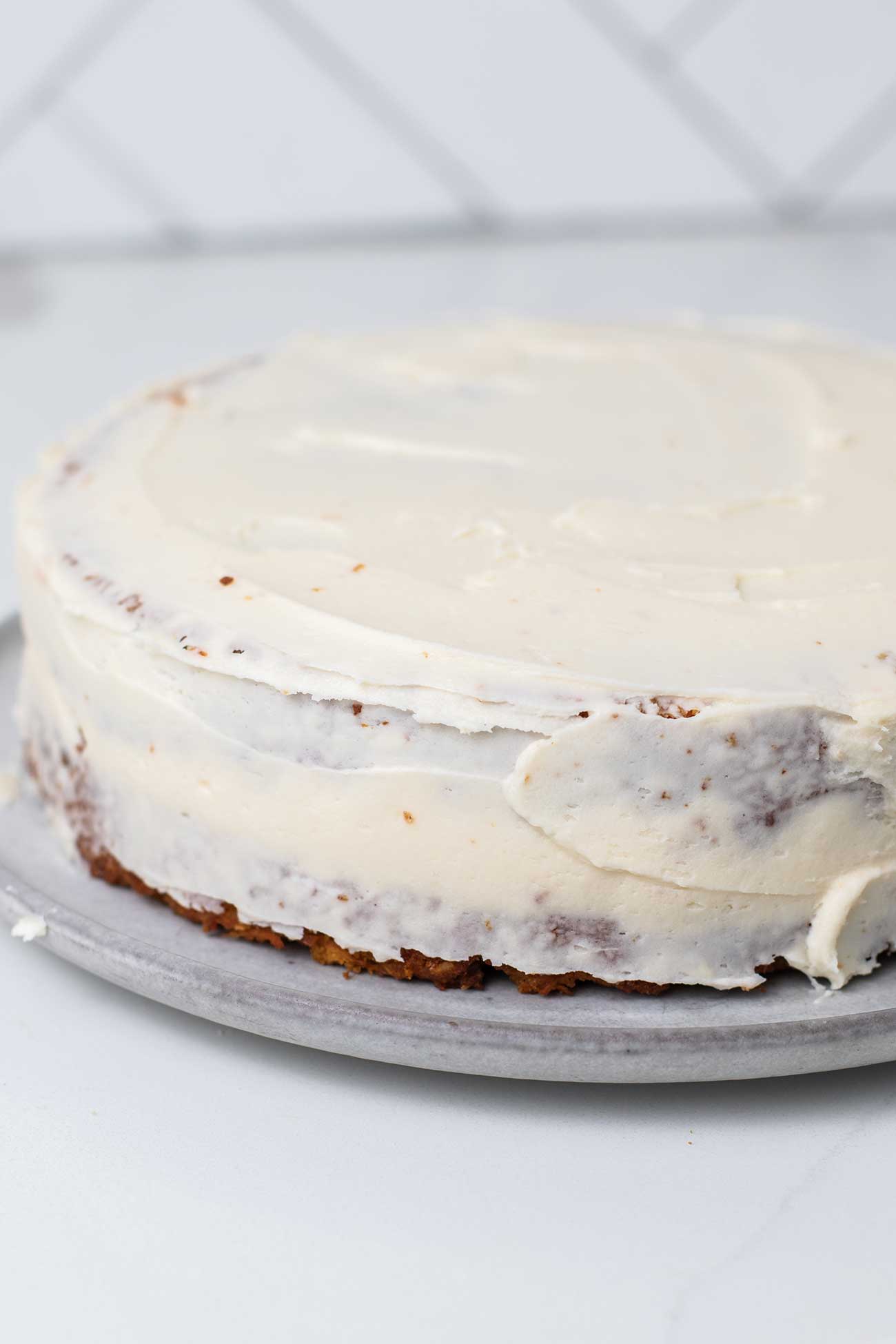 The second layer of carrot take added to the top with a very thin layer of frosting on the cake.