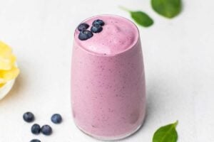 A creamy Greek yogurt smoothie garnished with blueberries.