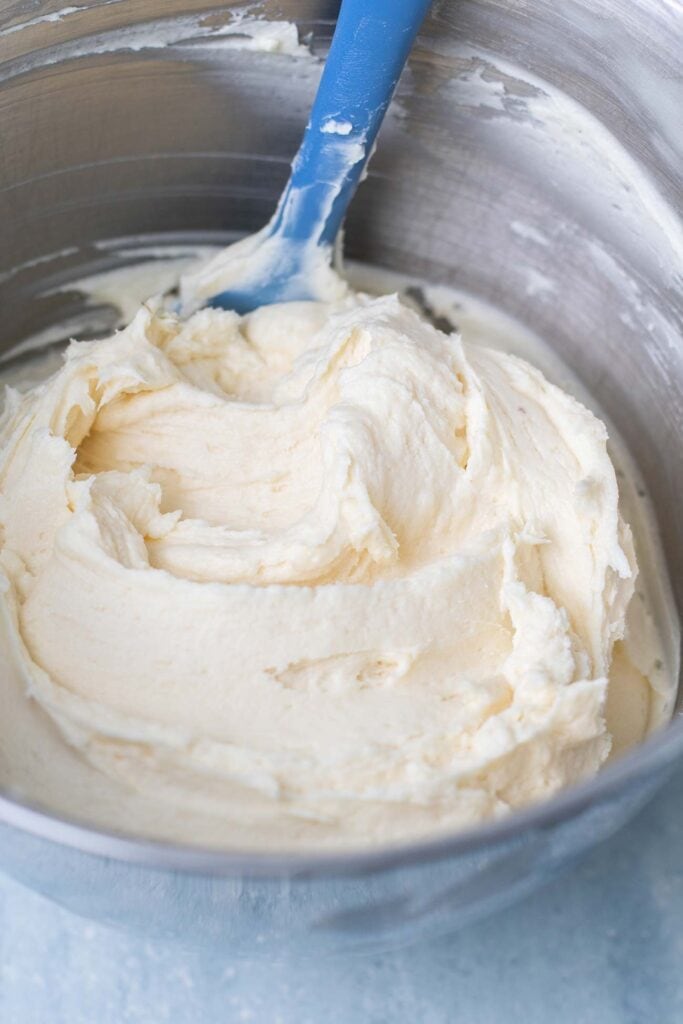 A mixing bowl of a creamy smooth cream cheese frosting.