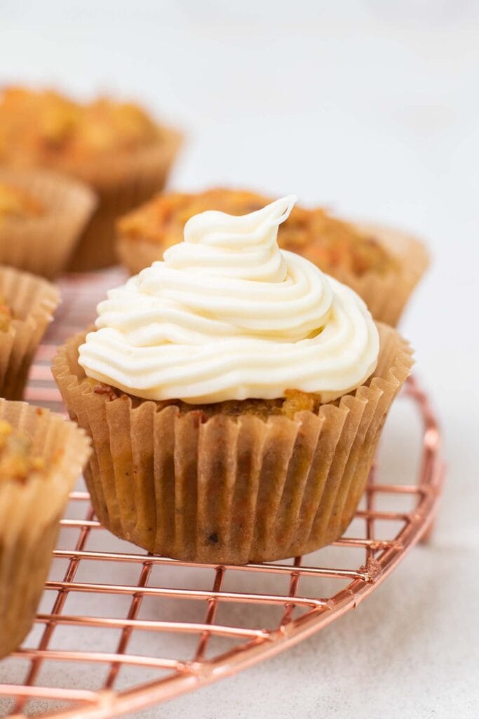 A cupcake topped with cream cheese frosting.