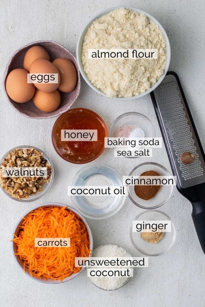 The ingredients needed to make a gluten free carrot cake shown with labels.