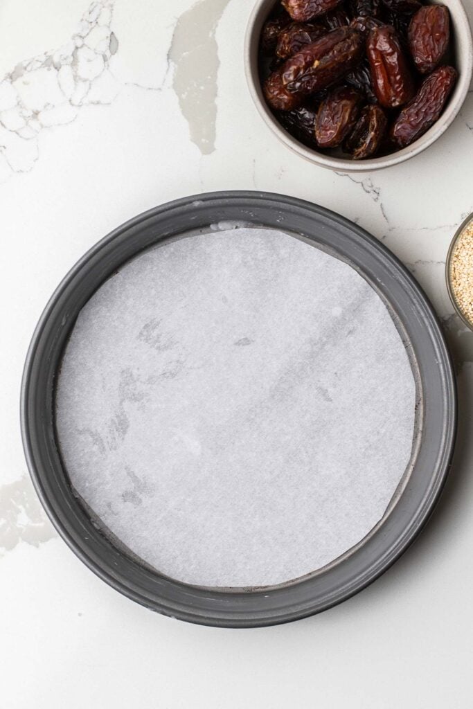 A cake pan lined with baking paper.