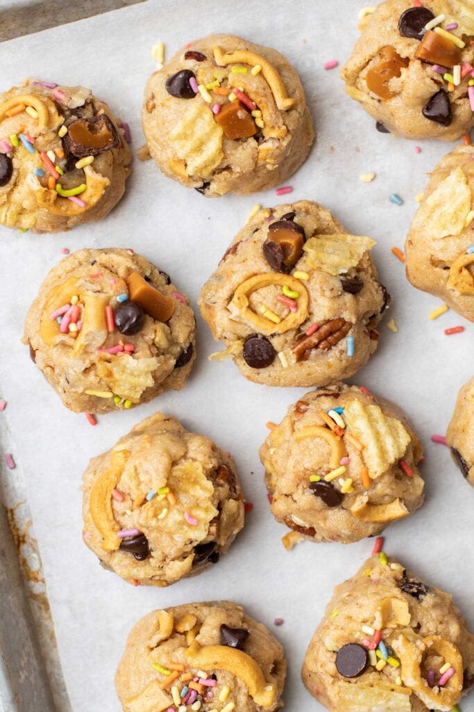 This shows how to make the best cookies by topping each one with little bits of all the ingredients so they bake into the tops of the cookies.