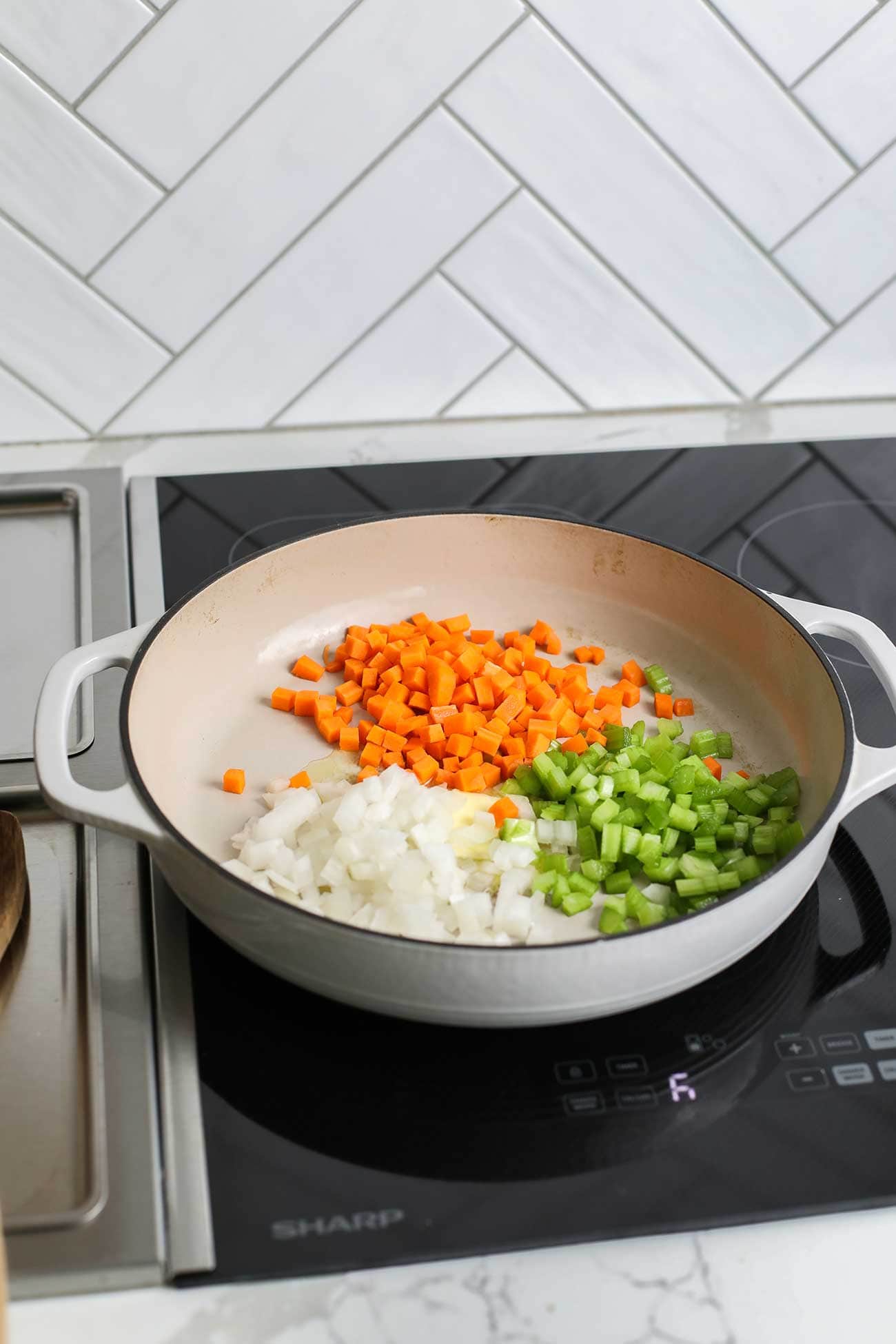 The onions, carrots and celery shown in a large skillet.