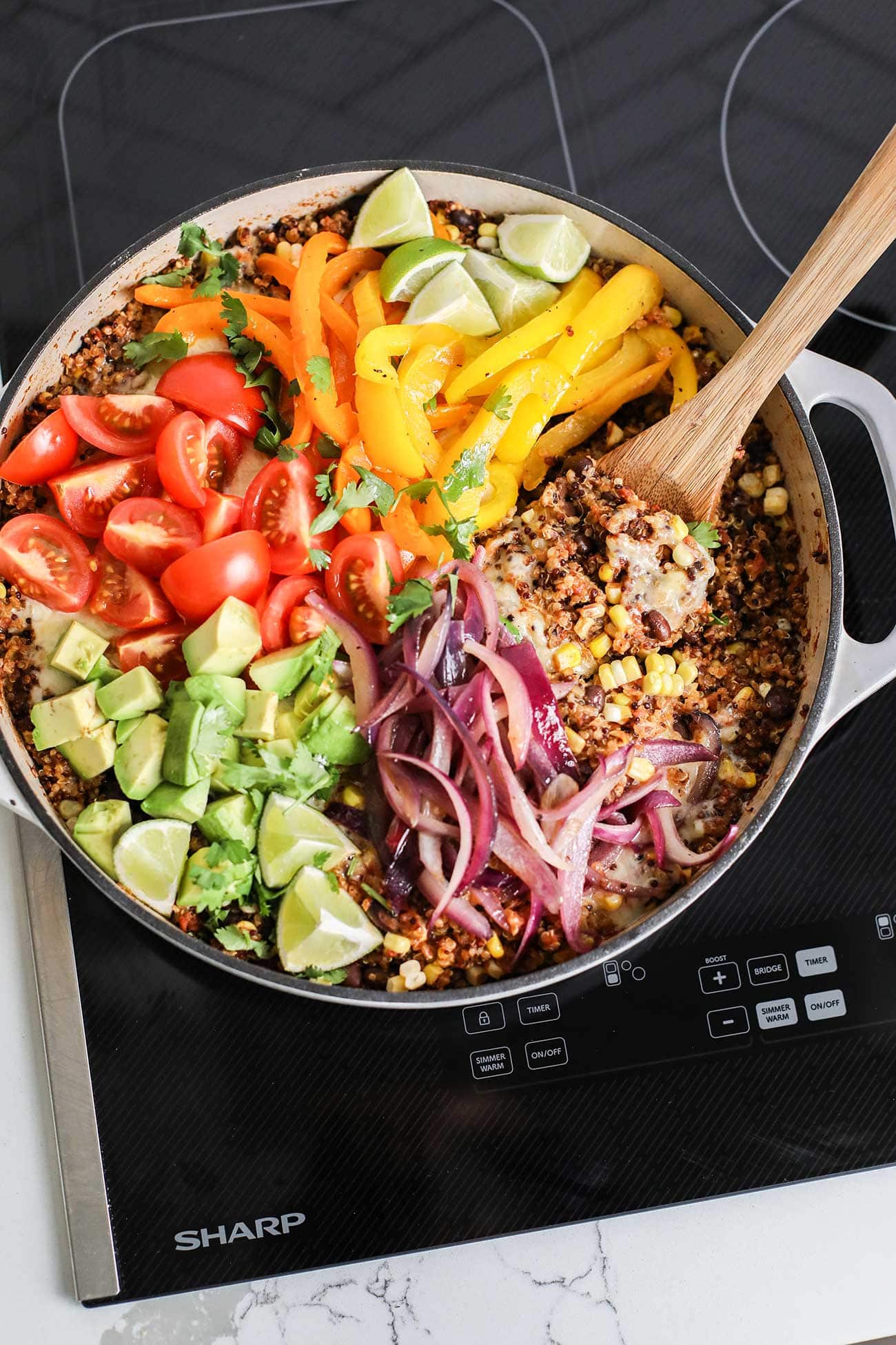A rainbow of toppings on a pan of mexican quinoa.