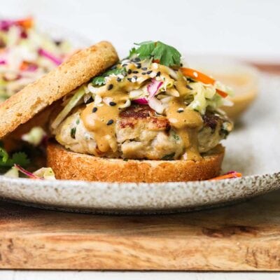 A thai chicken burger on a bun topped with an easy Asian slaw.