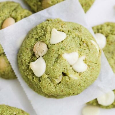 A stack of matcha cookies studded with large white chocolate chips.