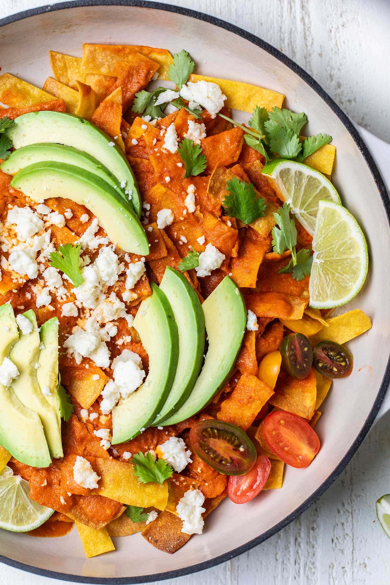 An close up look at Chilaquiles rojos in a large skillet.