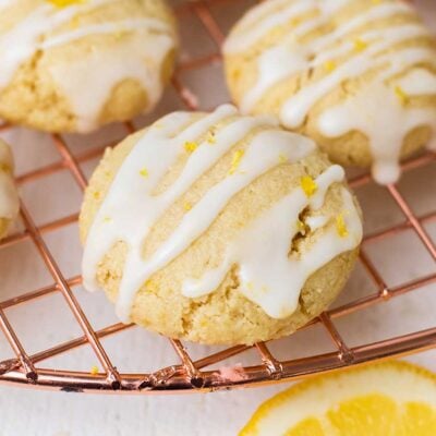 A lemon cookie shown drizzled with a lemon glaze.