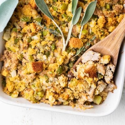 A baking dish showing a close up view of cornbread stuffing with sausage.