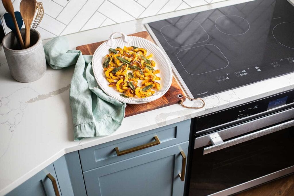 A platter of delicata squash sitting near the Sharp Induction Cooktop.
