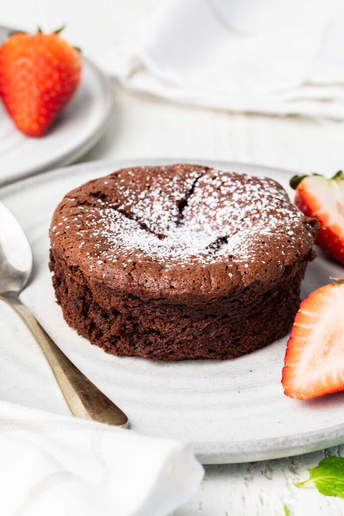 A chocolate souffle shown dusted with powdered sugar.