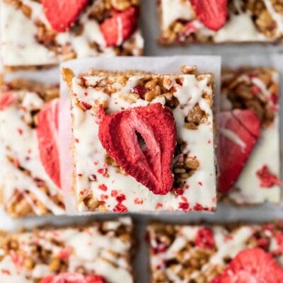 Rice crispy treats studded with freeze dried strawberries cut into squares.