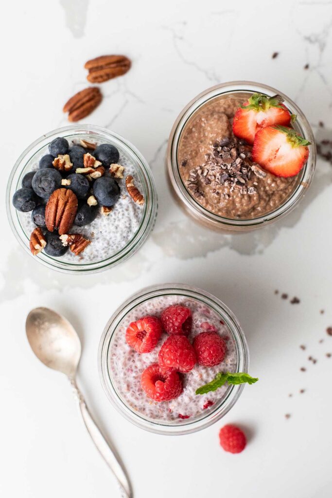 Three jars of chia pudding showing a variety of toppings.