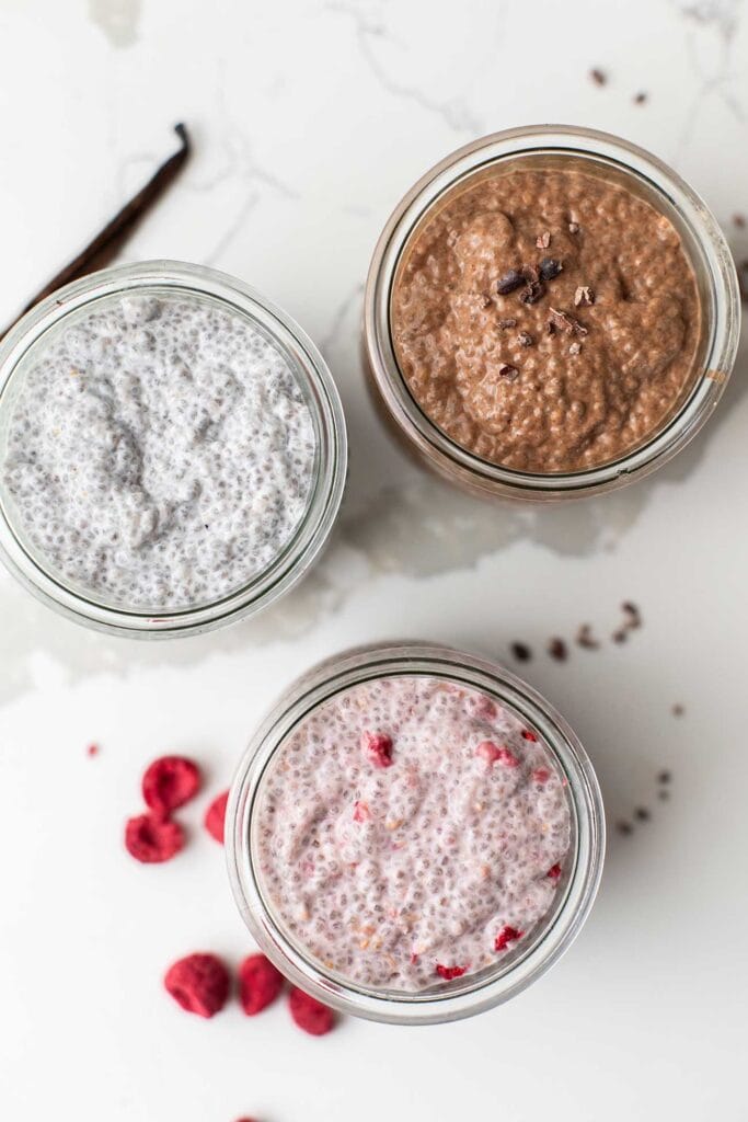Three flavors of chia seed pudding shown in jars.