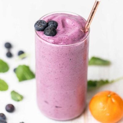 A cottage cheese smoothie shown with blueberries as a garnish.