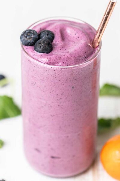 A cottage cheese smoothie shown with blueberries as a garnish.