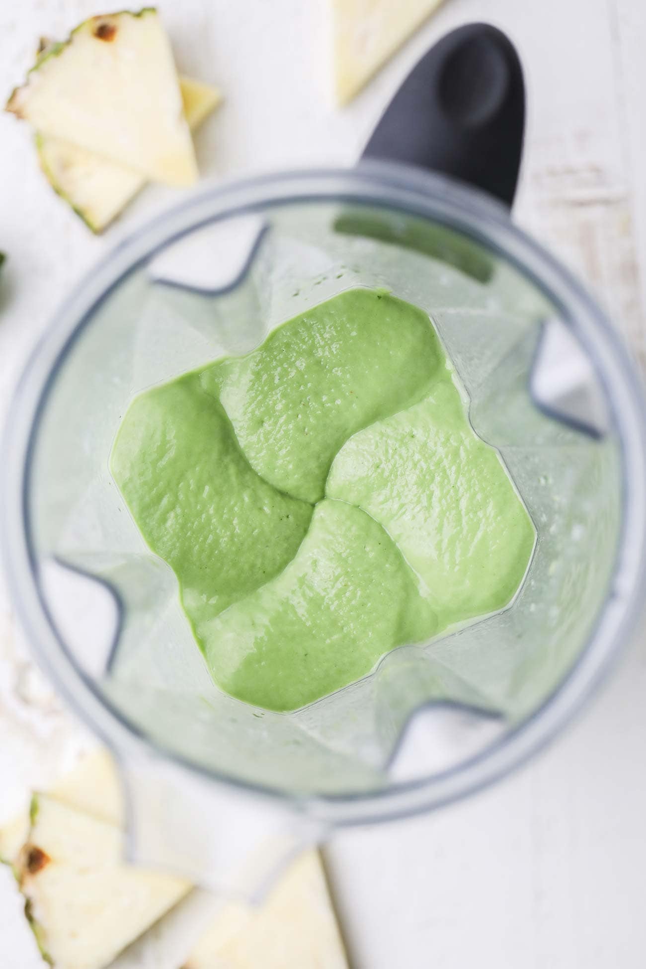 A creamy green smoothie in a blender.