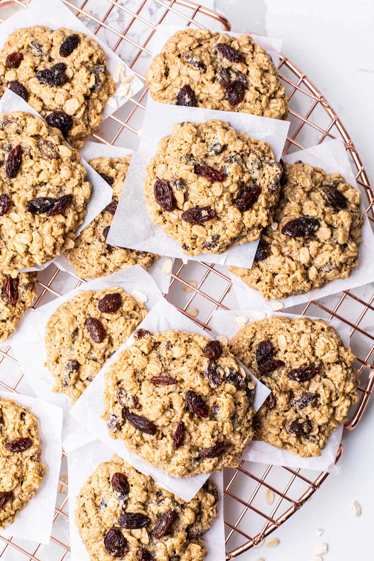 Healthy oatmeal raisin cookies shown stacked on a cooling rack.