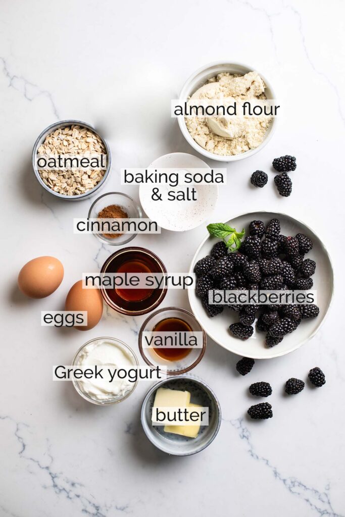 The ingredients needed for healthy blackberry muffins shown with labels.