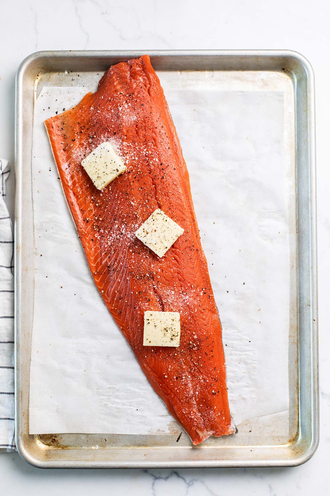 Step 2 shows adding the salmon to a sheet pan and seasoning it.