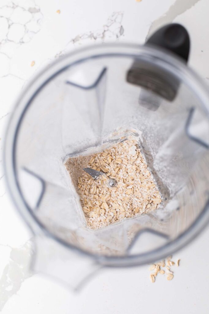 A blender showing oats processed into oat flour.