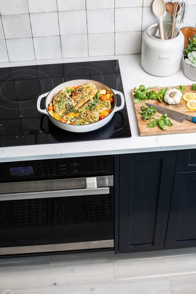 A pesto chicken skillet sitting on top of the Sharp Induction Cooktop.