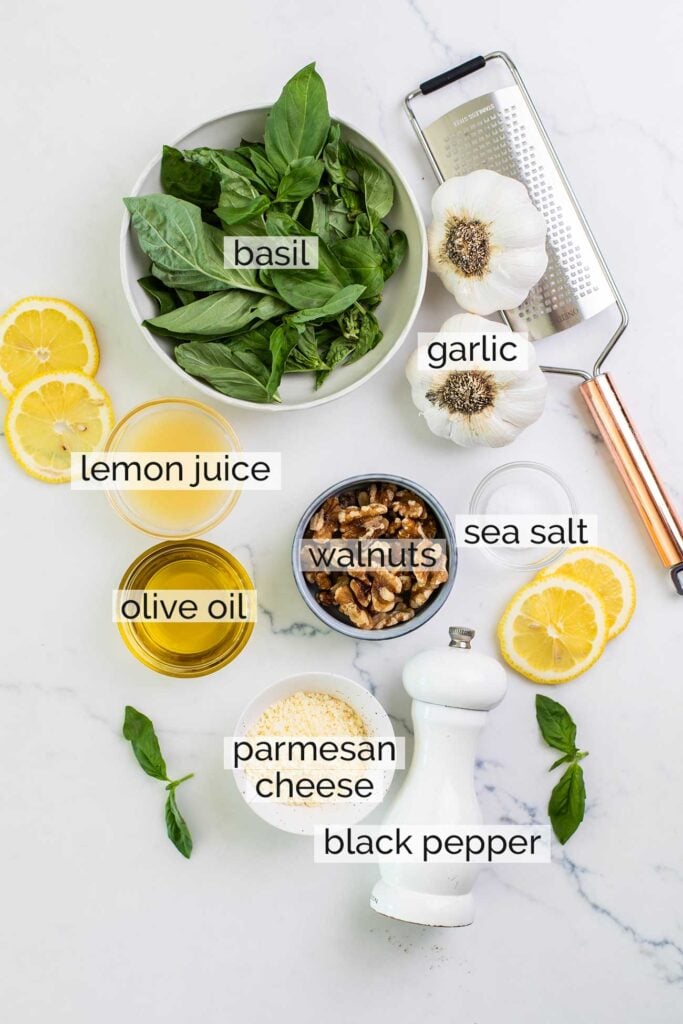 The ingredients in basil walnut pesto shown with labels.