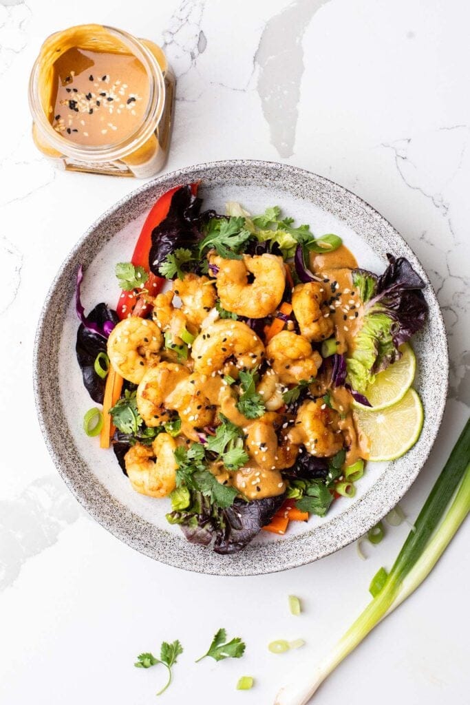 A Thai shrimp salad drizzled with a peanut sauce dressing.