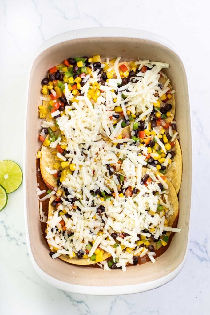 The middle layer of the enchilada casserole with a thick layer of black beans and vegetables.