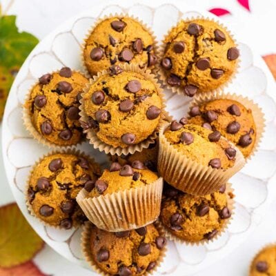 Gluten free pumpkin chocolate chip muffins shown on a cake stand.