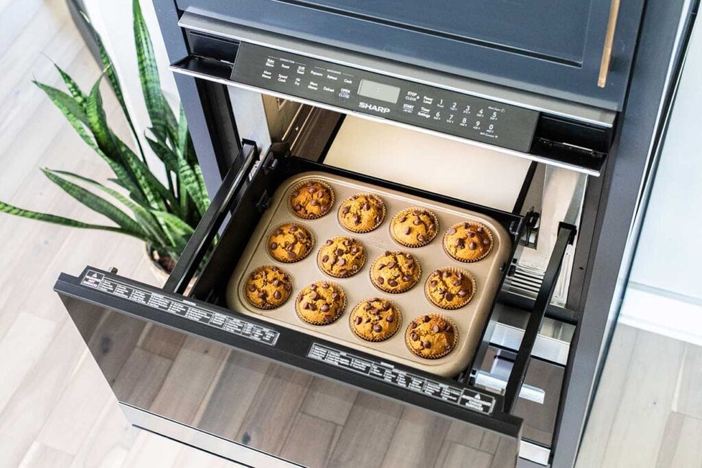 A muffin tin shown sitting inside the Sharp Microwave Drawer Oven.