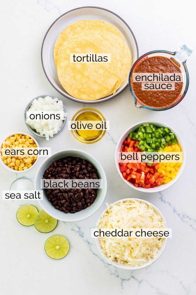 The ingredients needed to make a vegetarian enchilada casserole shown with labels.