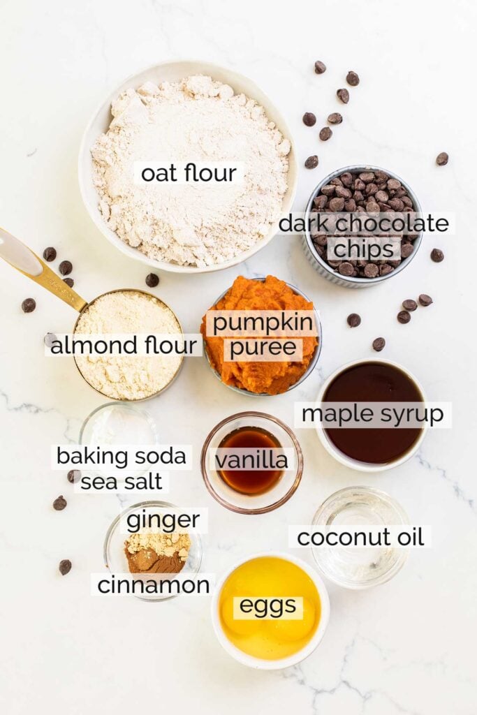 The ingredients needed to make healthy pumpkin chocolate chips muffins shown with labels.