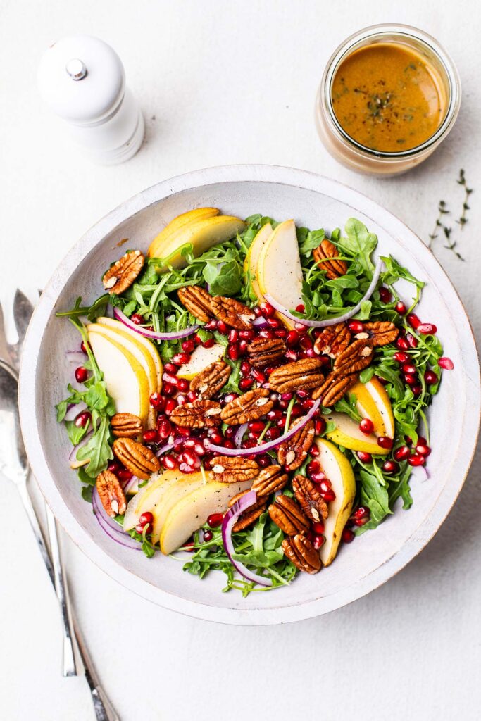 Arugula topped with pears, red onions, pomegranate, and pecans.