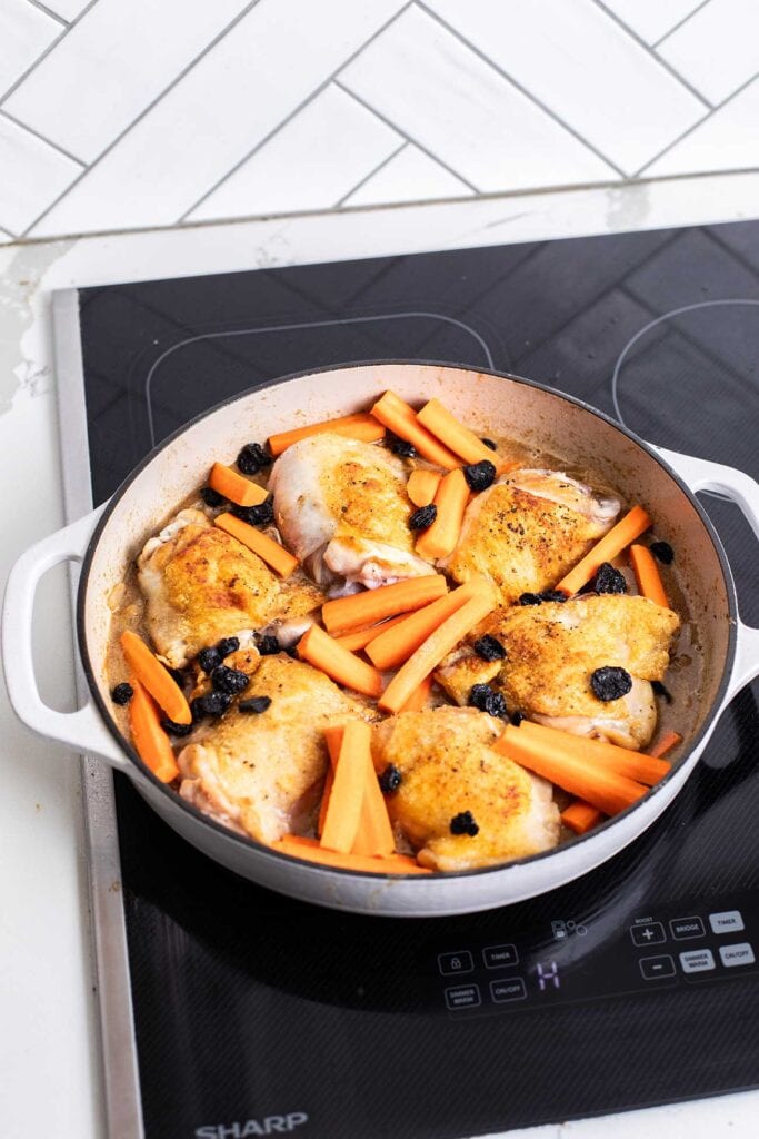 Step 5 shows adding the chicken thighs back in to the pot, along with dried apricots and carrots.