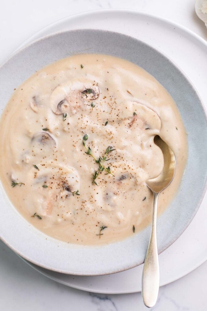 A thinner cream of mushroom soup shown in a soup bowl.