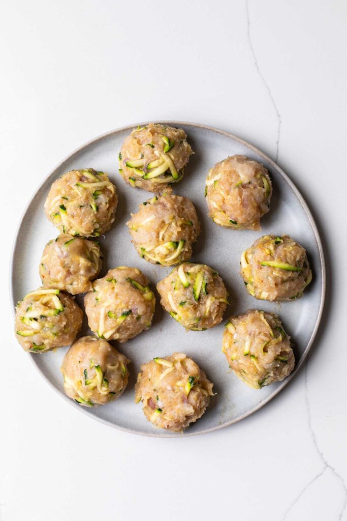 Raw meatballs on a plate.